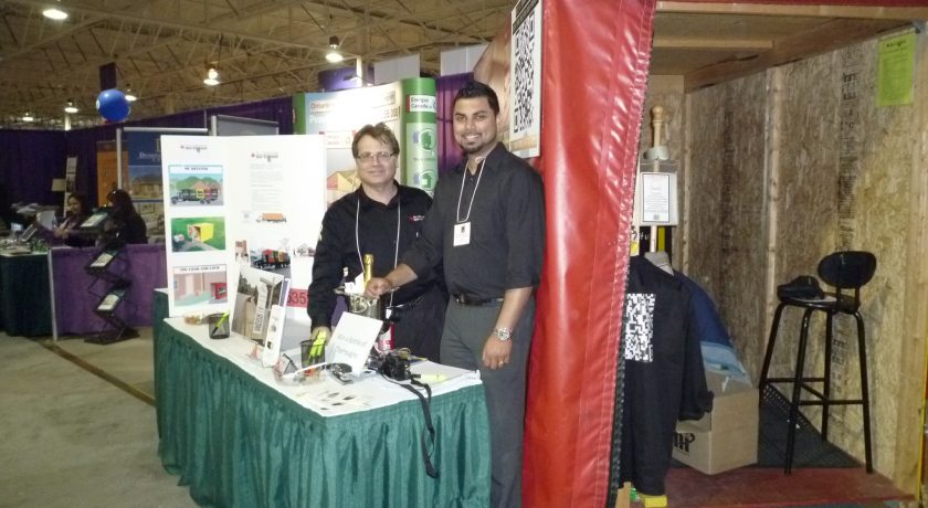 treb show, two men smiling in front of green and white table