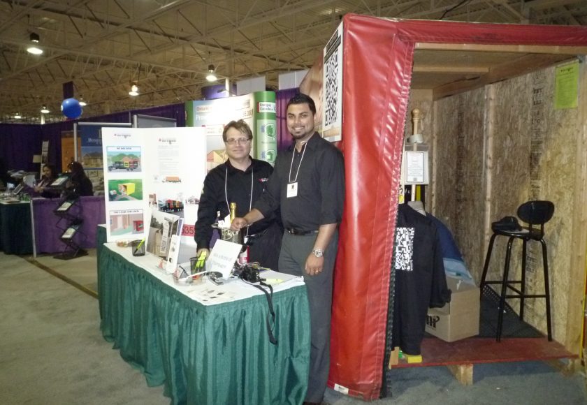 treb show, two men smiling in front of green and white table