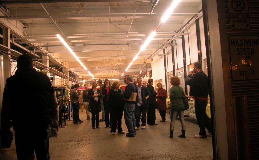 group of people standing in grey and white storage facility