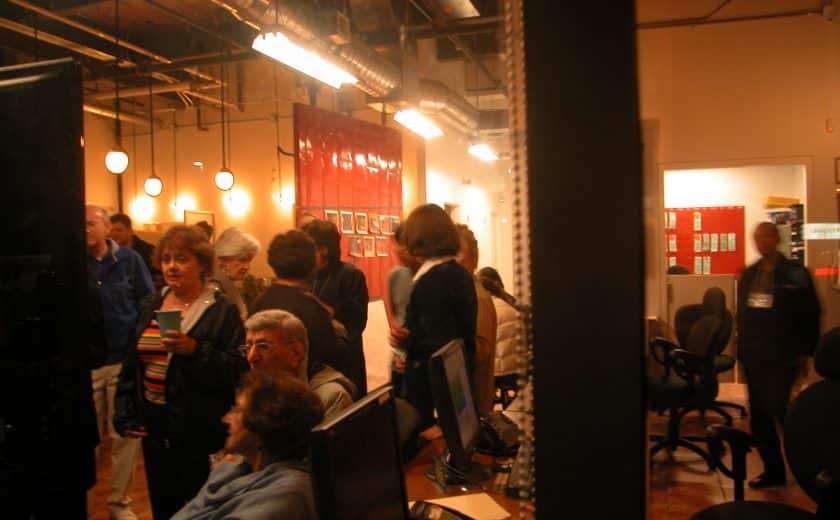 dark room with lights, group of people standing and sitting