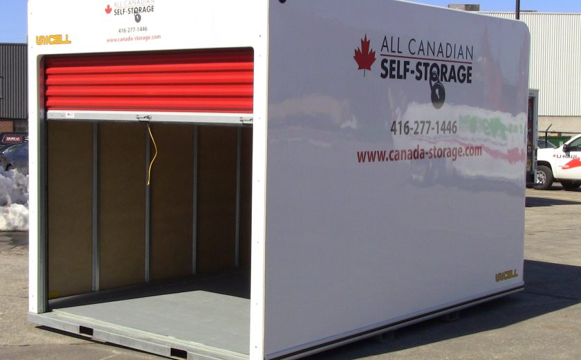 white storage unit with red door in parking lot, yellow string on door handle