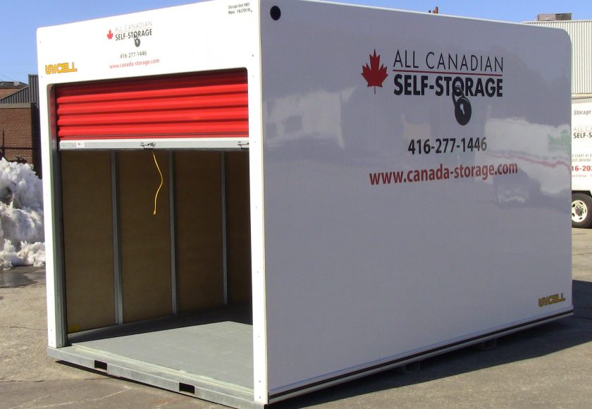 white storage unit with red door in parking lot, yellow string on door handle