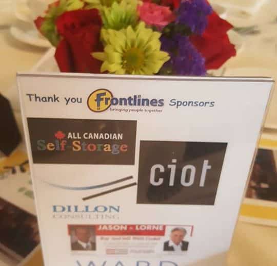 colourful flowers as the center piece of the table, small sign on the table with thank you frontlines sponsors