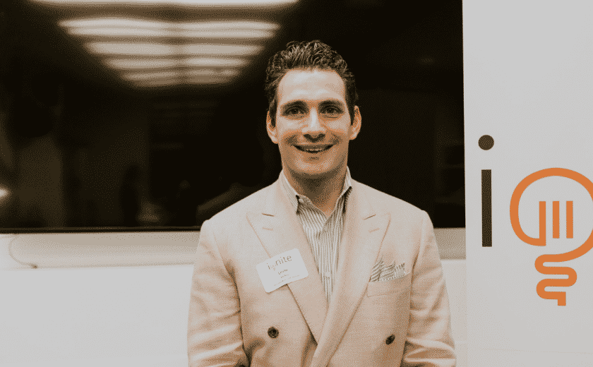 Leslie Kellen, man wearing a striped dress shirt and a light brown blazer jacket, standing and smiling at the camera, ignite capital pitch competition