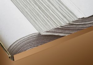 stack of white wrapping paper in brown box