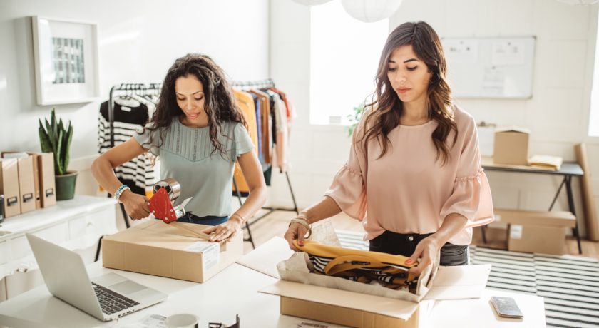 Working women at their store. They wearing casual clothing and accepting new orders online