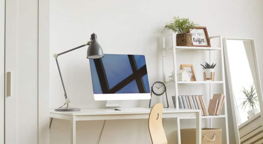 White Background image of empty home office workplace with wooden chair and modern computer on white desk, copy space